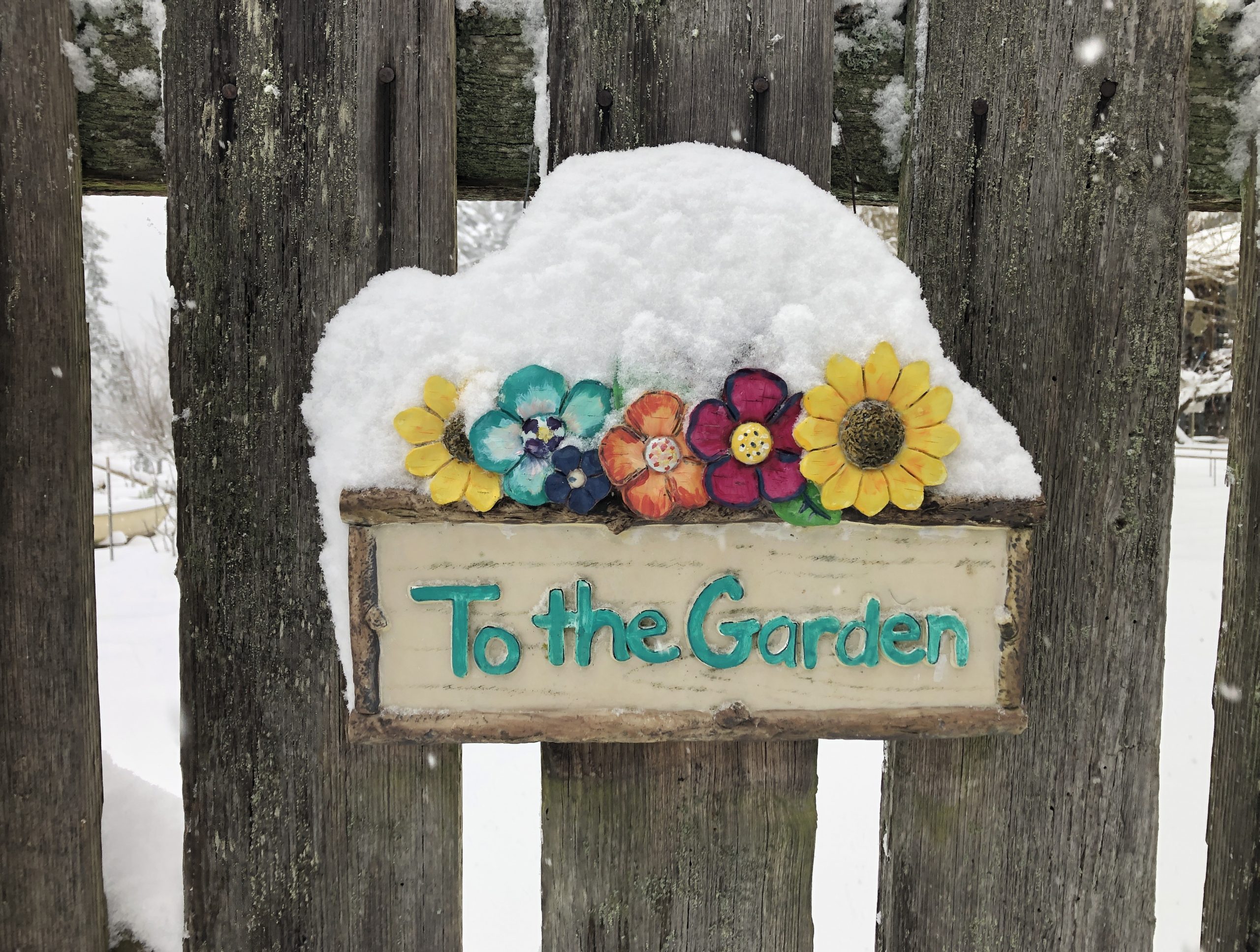Snow covered garden sign